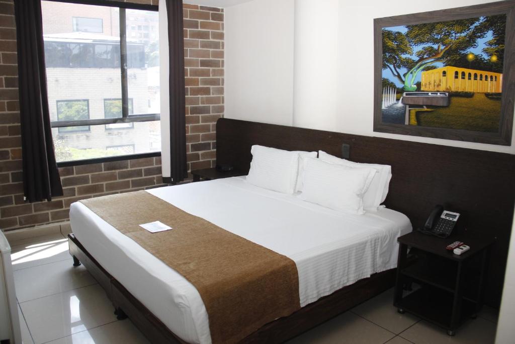 Postel nebo postele na pokoji v ubytování Hotel Acqua Medellín