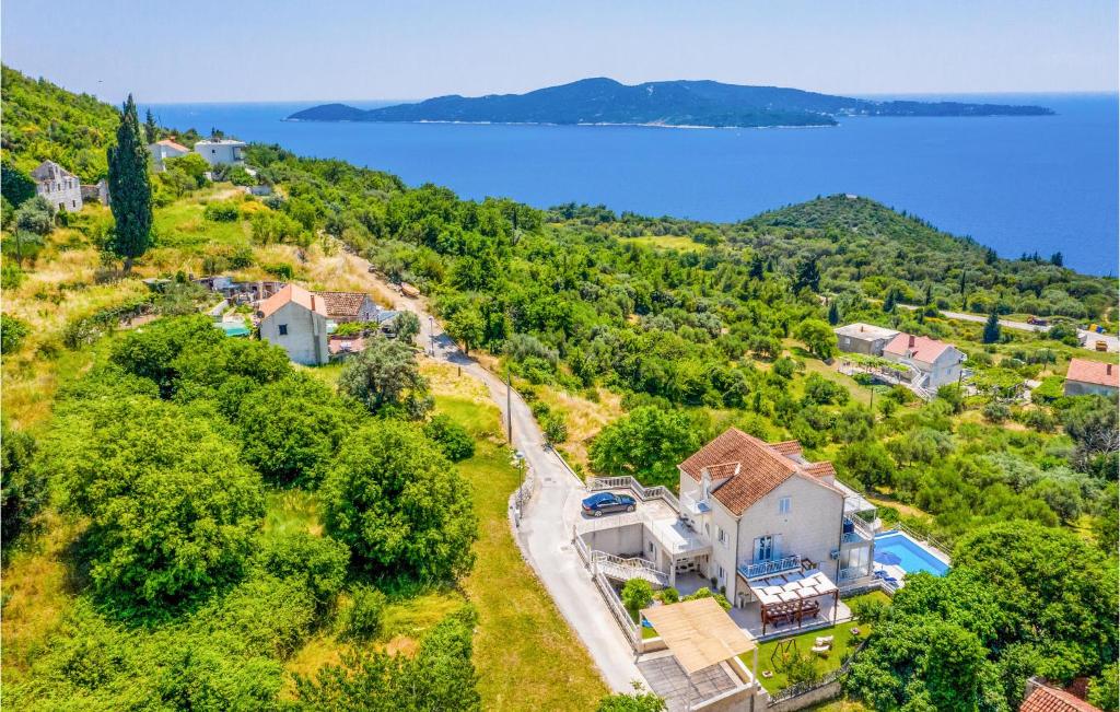 an aerial view of a house on a hill next to the water at Lovely Home In Trsteno With Private Swimming Pool, Can Be Inside Or Outside in Trsteno