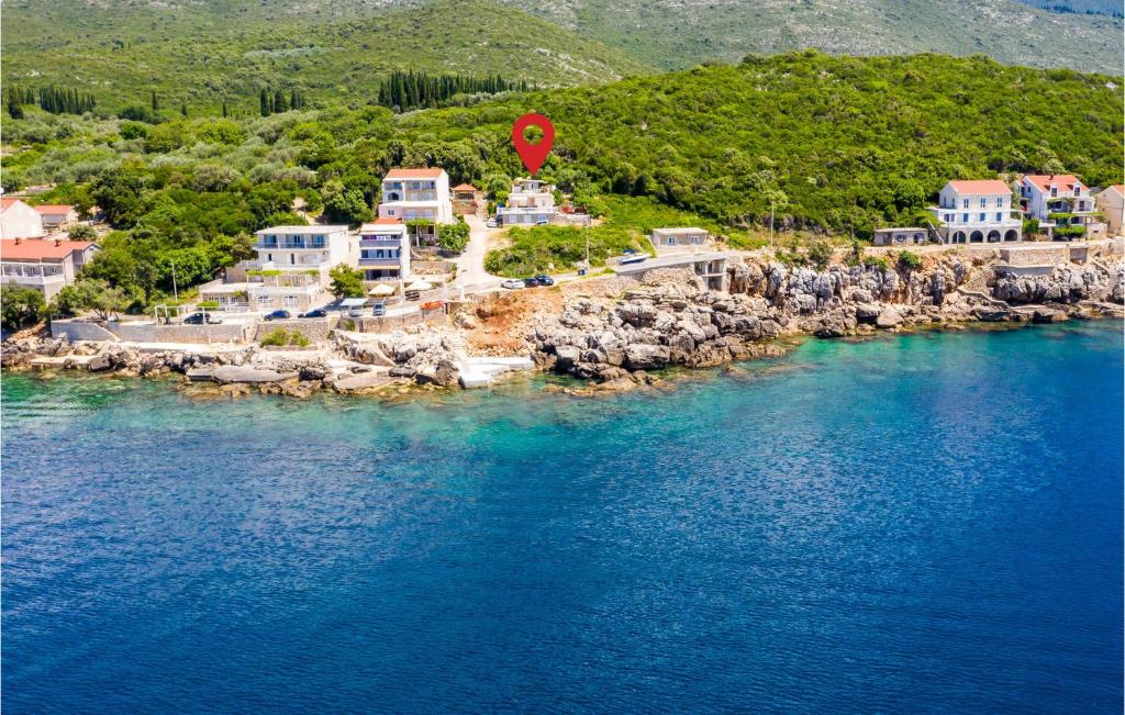 an island with a red stop sign in the water at Stunning Apartment In Gruda With Wifi in Gruda