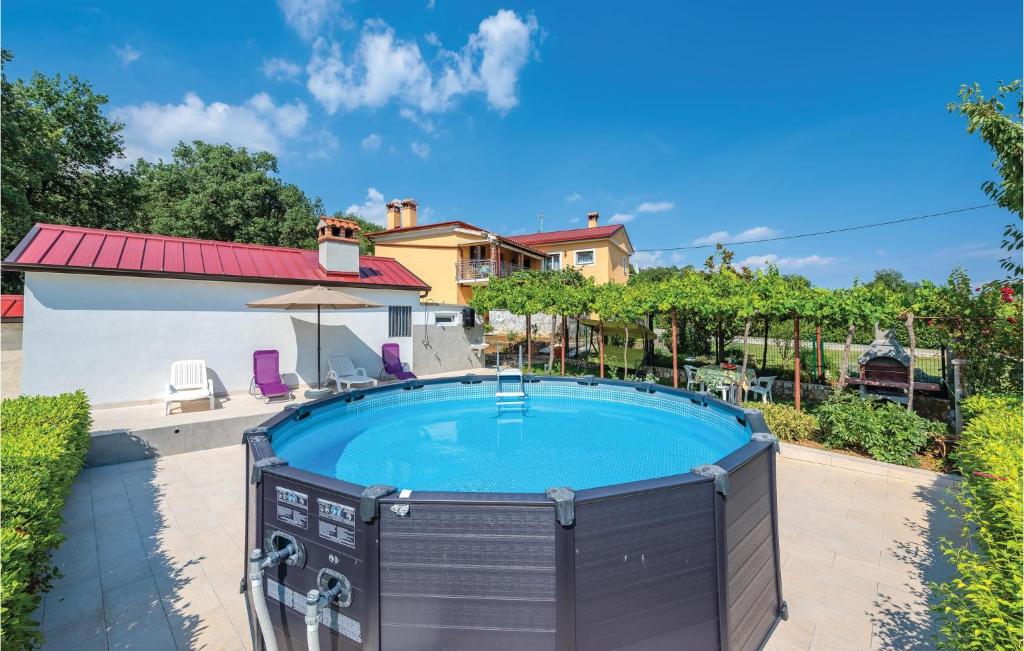 a pool in the backyard of a house at Cozy Apartment In Pican With Kitchen in Pićan