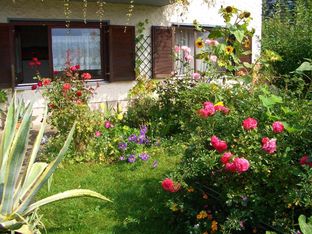 a garden of flowers in front of a house at Pension Krüger in Seeboden
