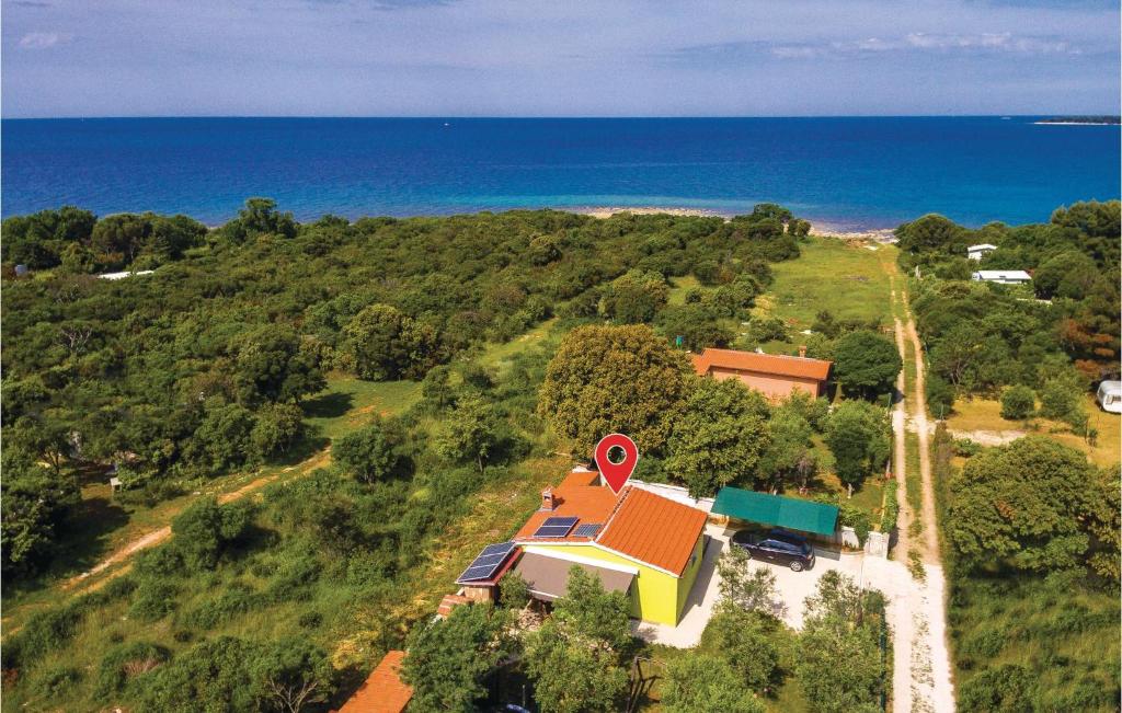 an aerial view of a house on a hill next to the ocean at Stunning Home In Peroj With Wifi in Peroj