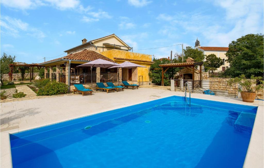 a swimming pool in front of a house at Gorgeous Home In Kras With Outdoor Swimming Pool in Kras