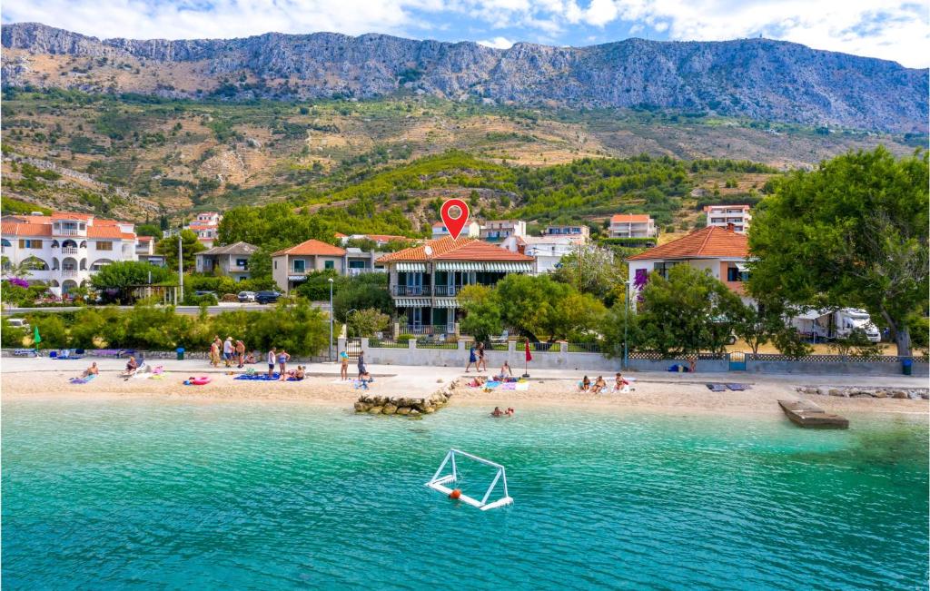 a beach with a boat in the water at Pet Friendly Home In Dugi Rat With House Sea View in Dugi Rat