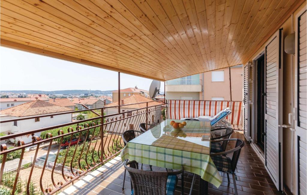 a balcony with a table and chairs on it at 3 Bedroom Stunning Apartment In Trogir in Trogir