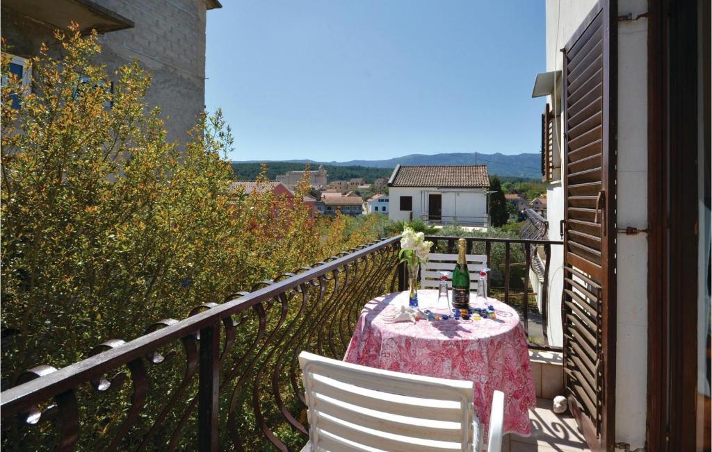 a table on a balcony with a table and chairs at Beautiful Apartment In Vrboska With Kitchenette in Vrboska