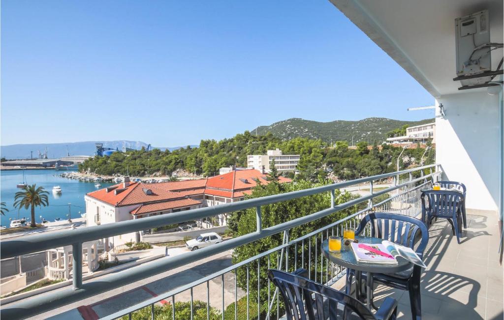 a balcony with tables and chairs and a view of the water at Gorgeous Apartment In Ploce With Wifi in Ploče