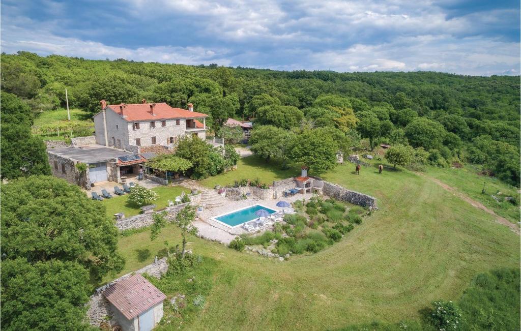 an aerial view of a large house with a swimming pool at Pet Friendly Home In Gora Glusic With House Sea View in Stanišovi