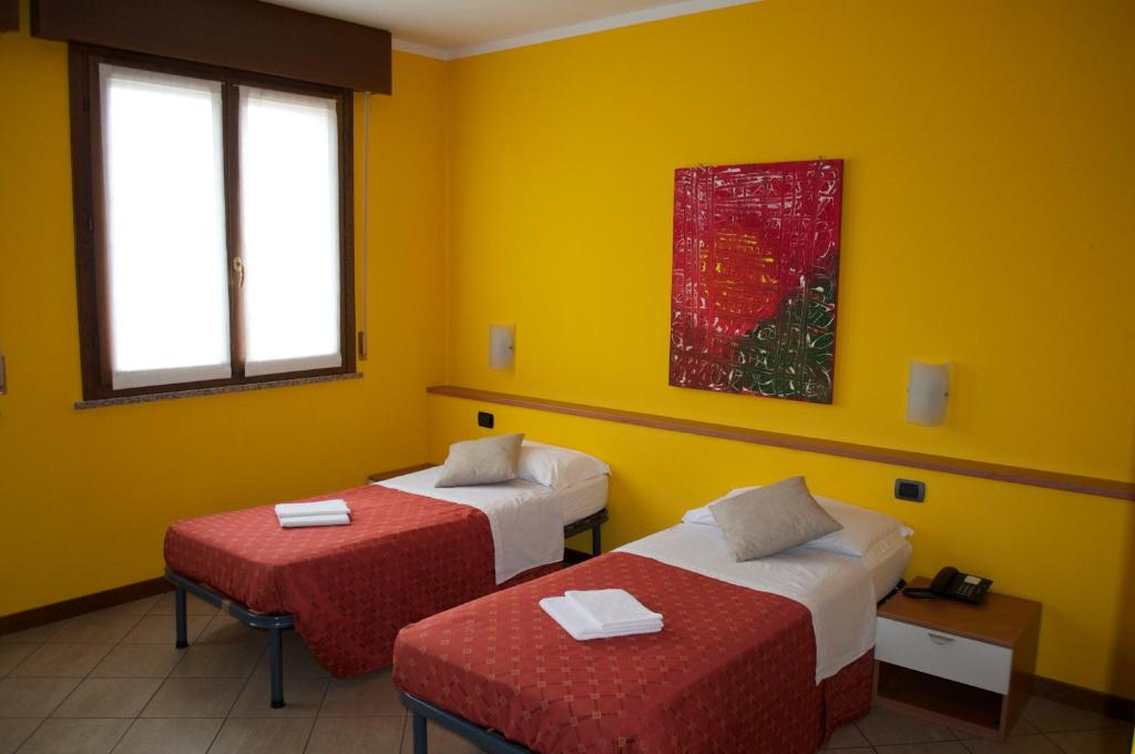Postel nebo postele na pokoji v ubytování Hotel Mantova Sud