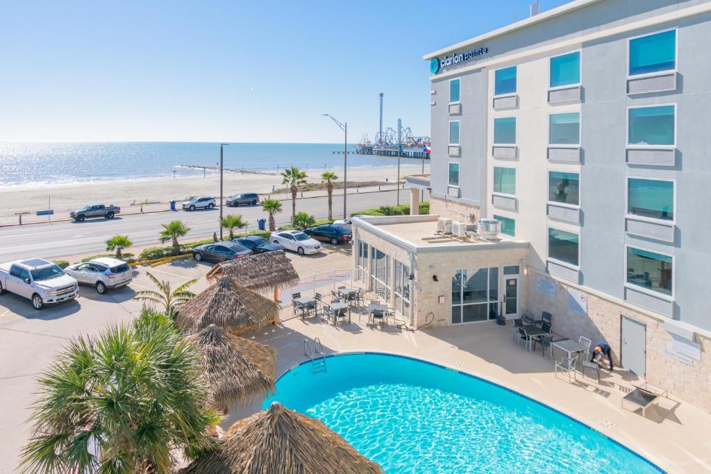 an overhead view of a hotel with a swimming pool and the beach at Clarion Pointe Galveston Seawall in Galveston