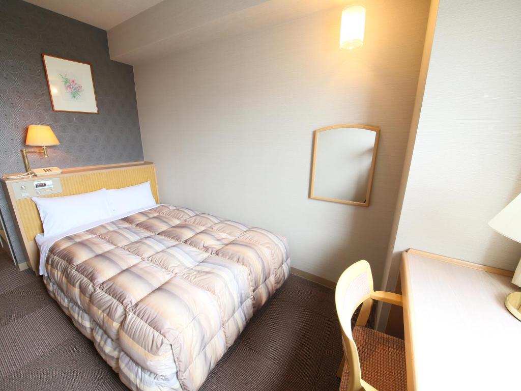 Postel nebo postele na pokoji v ubytování Rako Hananoi Hotel