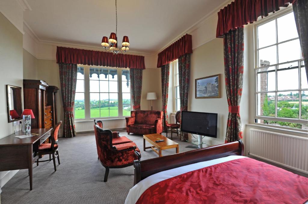 a living room filled with furniture and a large window at Royal Hotel by Greene King Inns in Ross on Wye