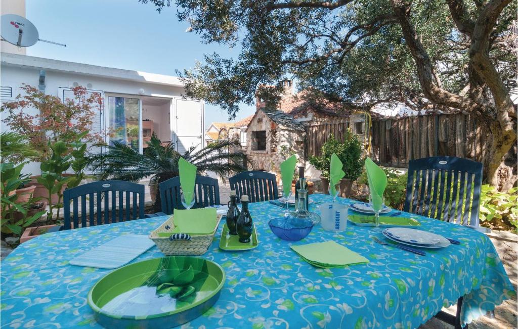 uma mesa com uma toalha de mesa azul e verde em Amazing Apartment In Supetar With Kitchen em Supetar