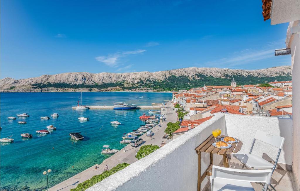 a view of a harbor from a balcony with boats in the water at 2 Bedroom Gorgeous Home In Baska in Baška