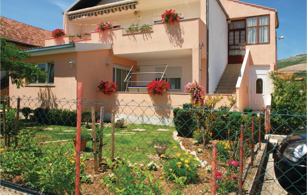 a house with a garden in front of it at 3 Bedroom Beautiful Apartment In Kastel Novi in Kastel Novi