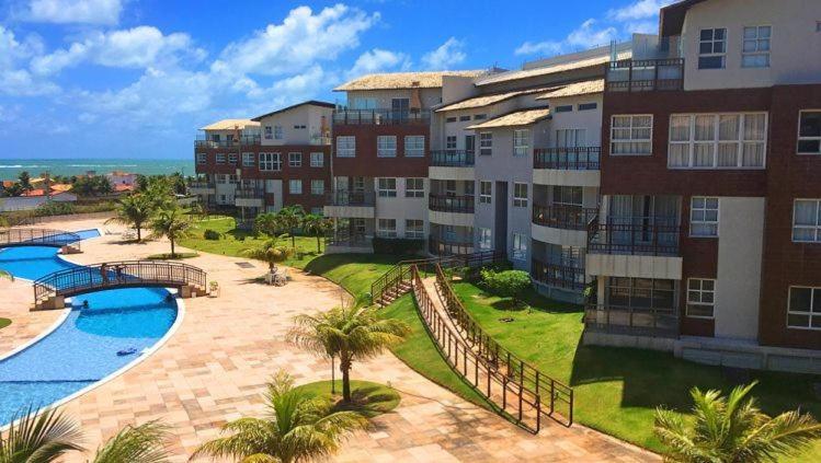 an apartment complex with a swimming pool and a resort at Casa do Chico Cond Golden Dunas in Extremóz