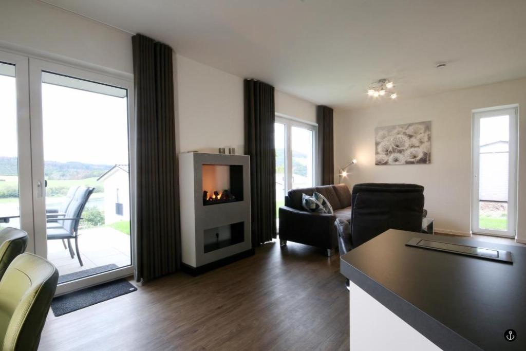 a living room with a couch and a fireplace at NINA - Sonnenweg 20 in Heringhausen