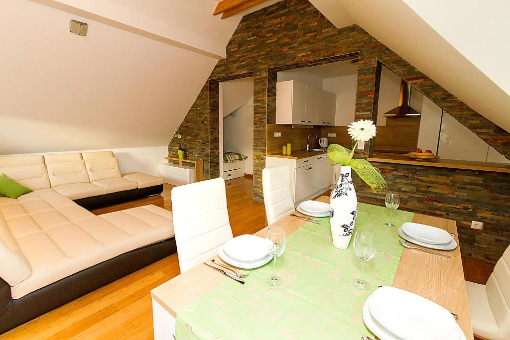 a living room with a dining table and a kitchen at Apartments Bohinjskih 7 in Bohinj