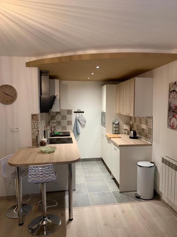 a kitchen with a island in the middle of a room at Le moulin des 2 roues in Meung-sur-Loire