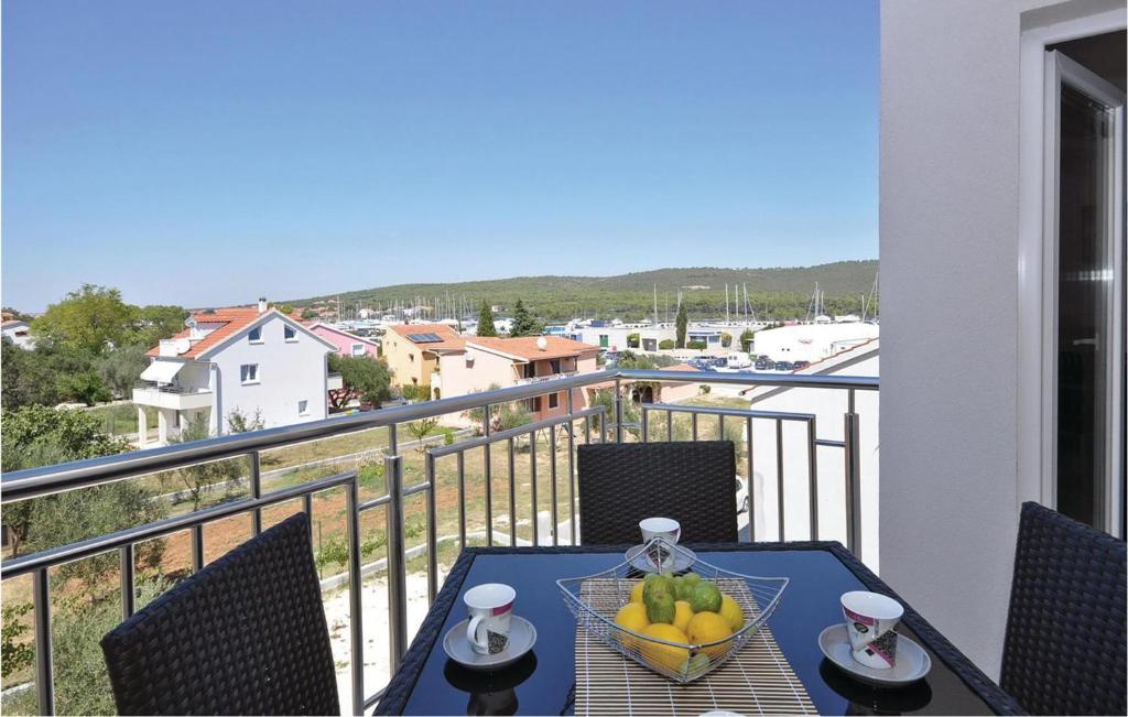 a table with a bowl of fruit on a balcony at 1 Bedroom Cozy Apartment In Bibinje in Bibinje