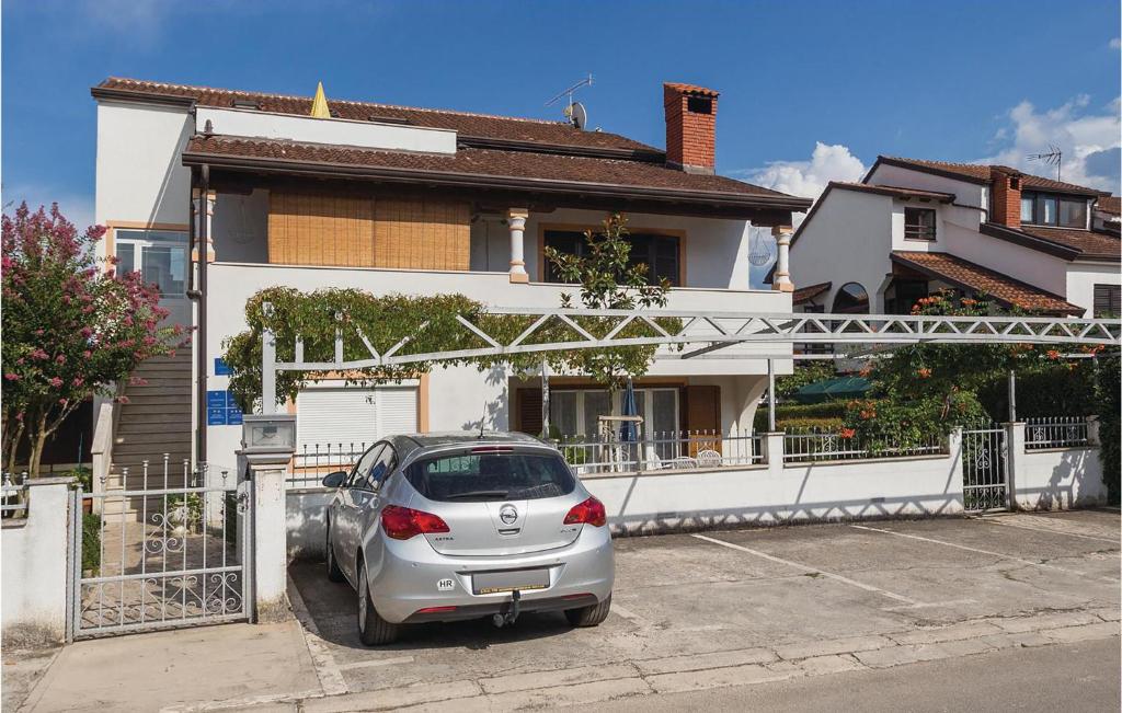 a silver car parked in front of a house at Amazing Apartment In Porec With 2 Bedrooms And Wifi in Poreč