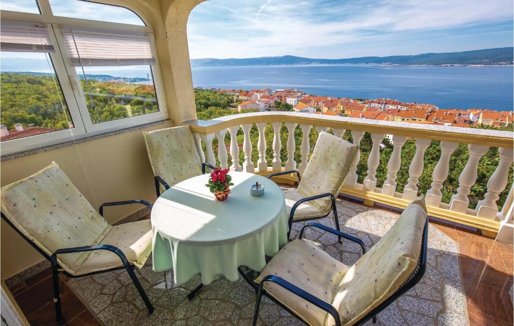 a table and chairs on a balcony with a view of the water at 2 Bedroom Gorgeous Apartment In Crikvenica in Crikvenica