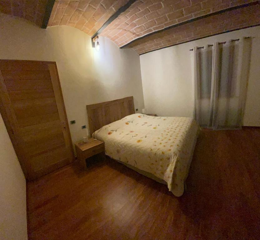 Postel nebo postele na pokoji v ubytování PODERE GRETANO casetta in maremma