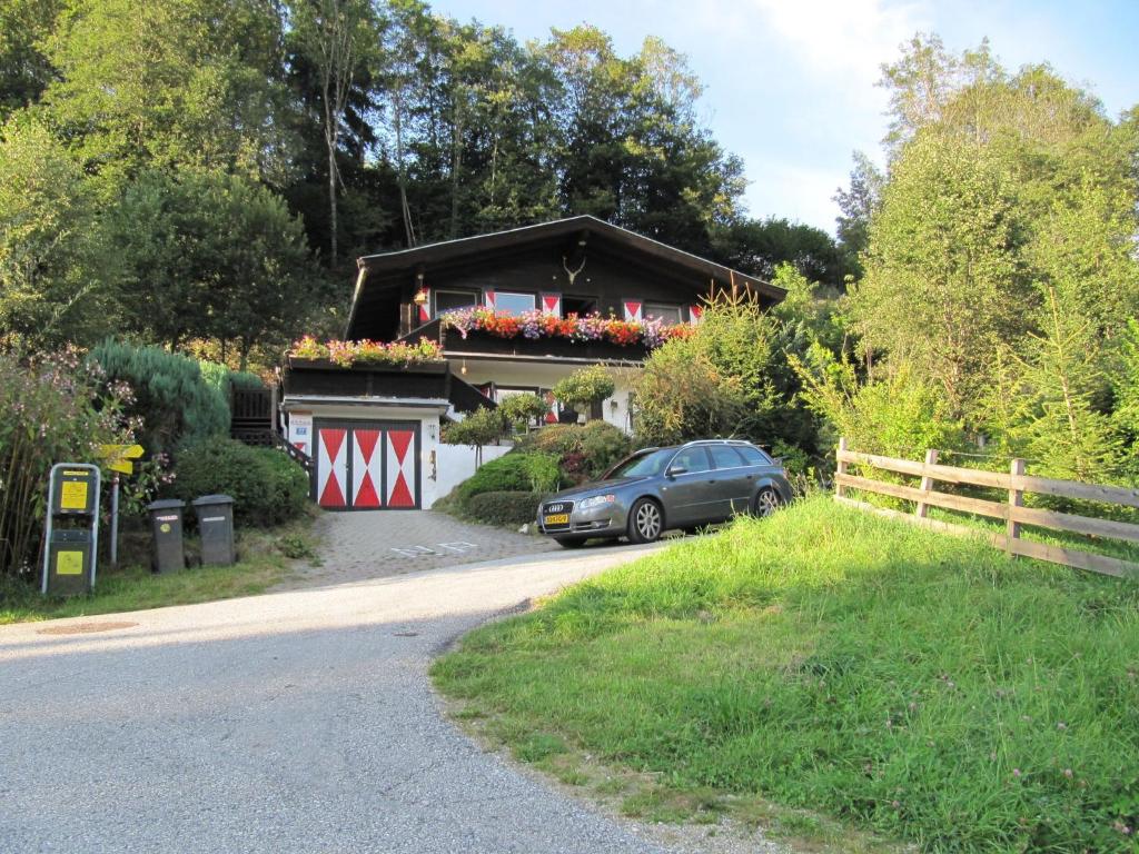 a car parked in front of a house at Comfy Chalet in Niedernsill with Fireplace in Niedernsill