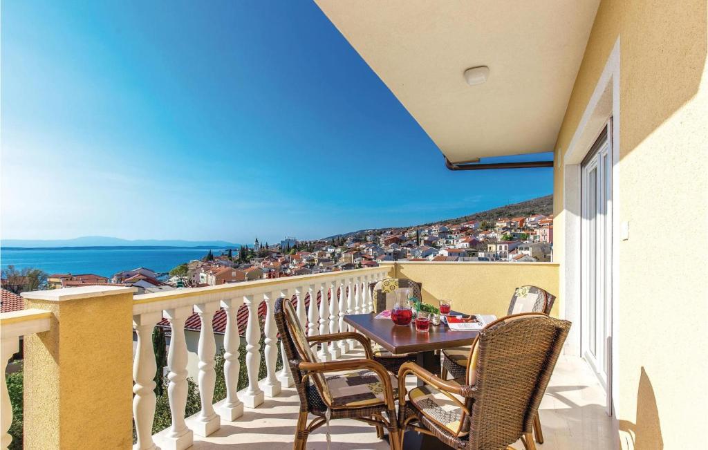 a table and chairs on a balcony with a view at 1 Bedroom Gorgeous Apartment In Selce in Selce