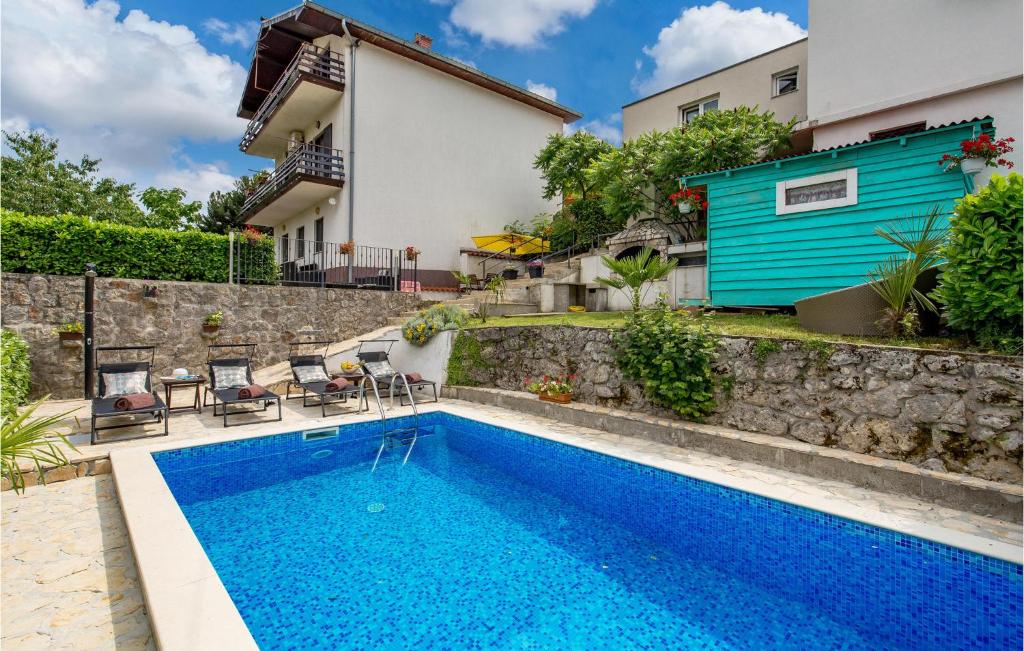 a swimming pool in front of a house at Stunning Apartment In Rukavac With 2 Bedrooms, Wifi And Outdoor Swimming Pool in Rukavac