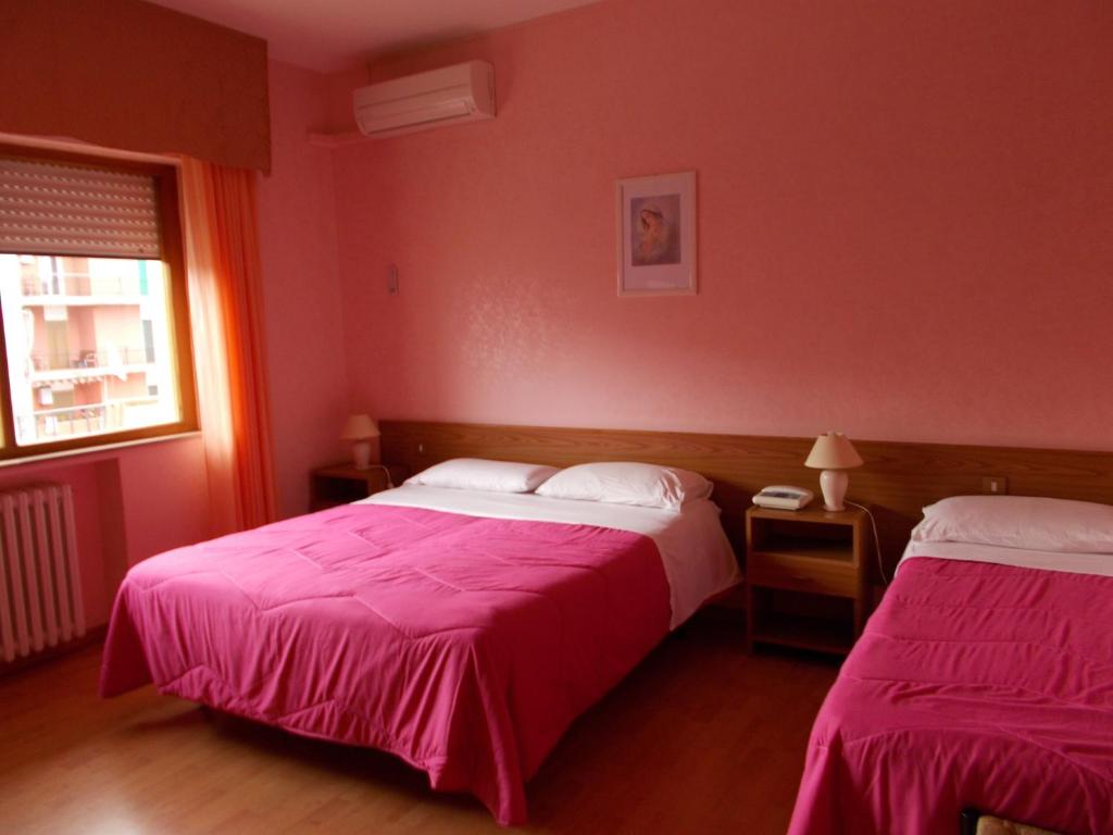 Postel nebo postele na pokoji v ubytování Hotel Maremonti