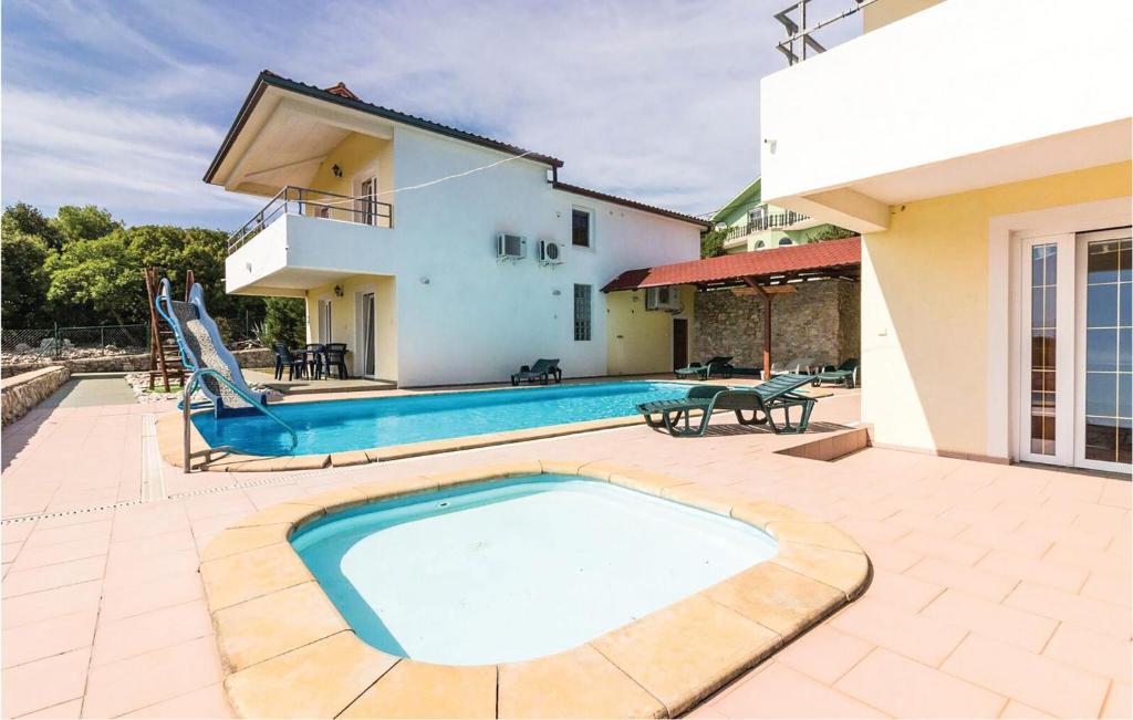 a swimming pool in the backyard of a house at Nice Apartment In Labin With Outdoor Swimming Pool in Diminići