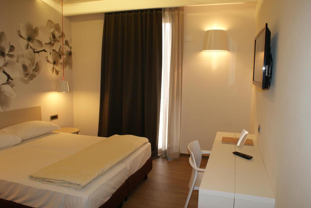 Postel nebo postele na pokoji v ubytování Hotel Corte Quadri