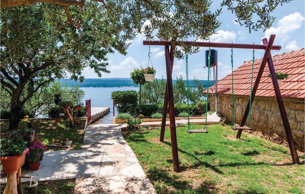 a swing yard with a view of the water at Beautiful Apartment In Krusevo With 1 Bedrooms And Wifi in Podorjak