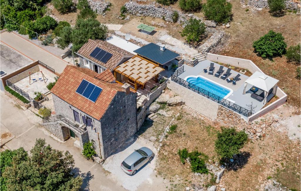 an overhead view of a house with a swimming pool at Beautiful Home In Smokvica With Wifi in Smokvica