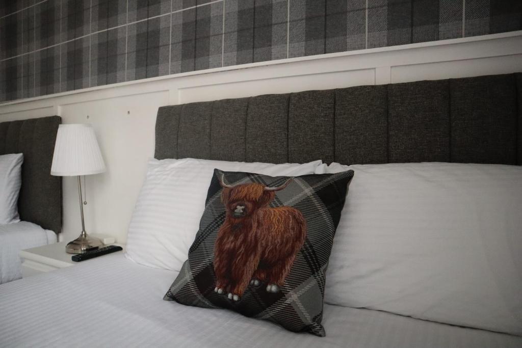 a picture of a cow on a pillow on a bed at Harbourside Hotel in Irvine