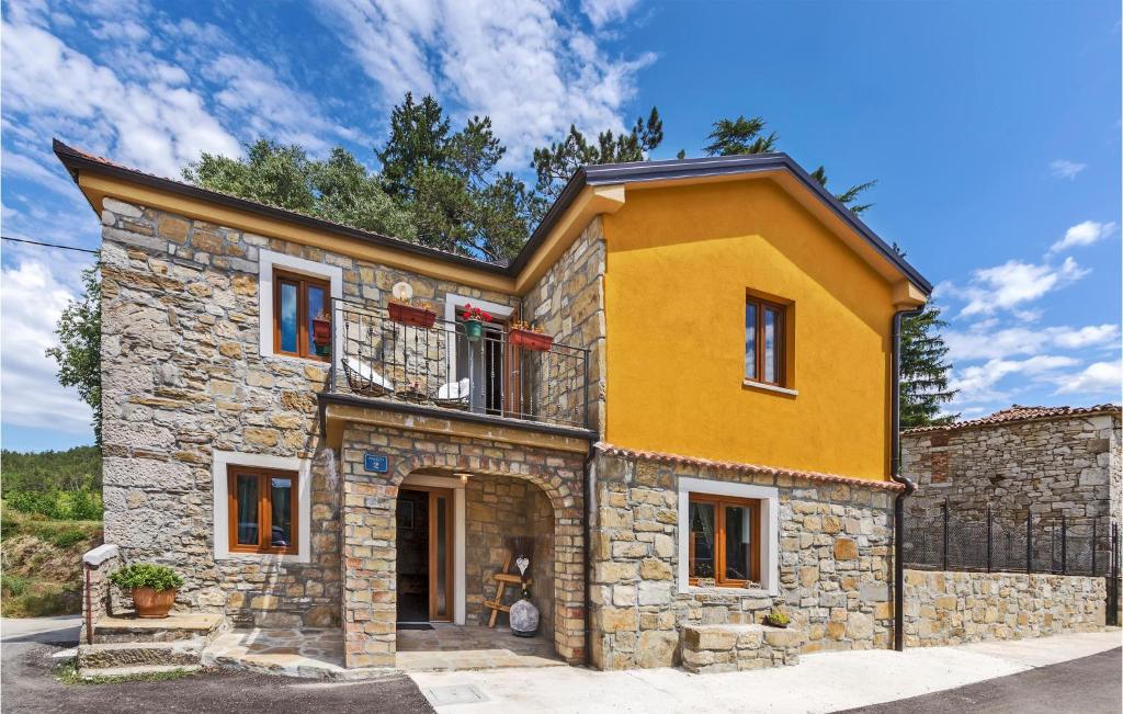 a yellow house with a balcony on top of it at Nice Home In Zarecje With Wifi in Zarečje