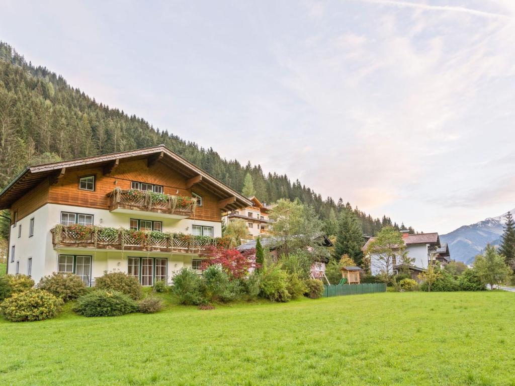 a house in the mountains with a green field at Modern Apartment with Sauna in Gro arl Salzburg in Grossarl