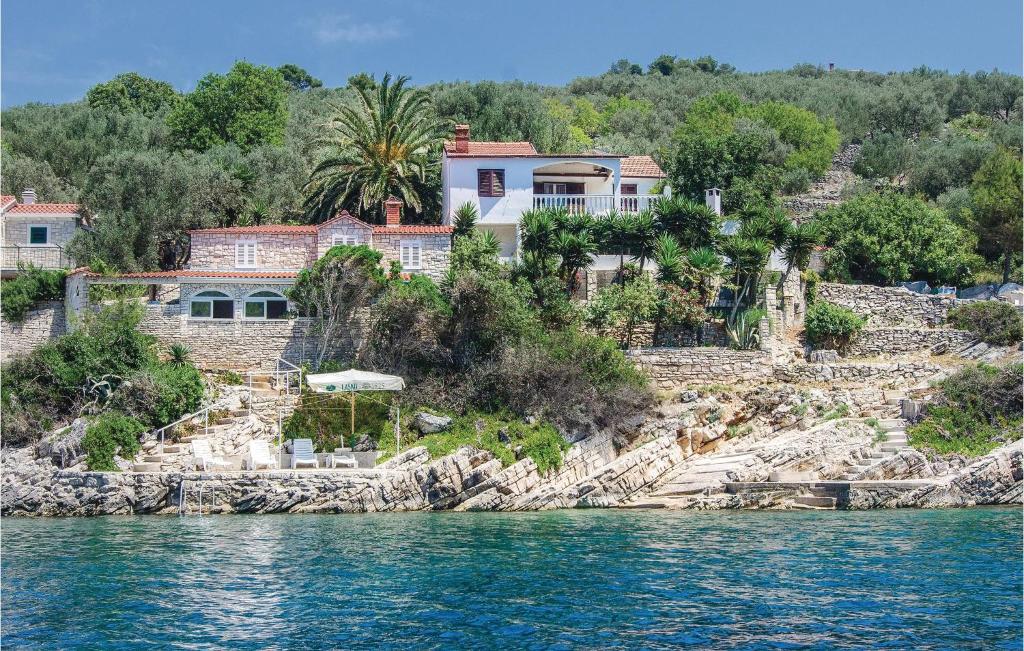 a house on a rocky island in the water at Beautiful Home In Vela Luka With 3 Bedrooms in Vela Luka