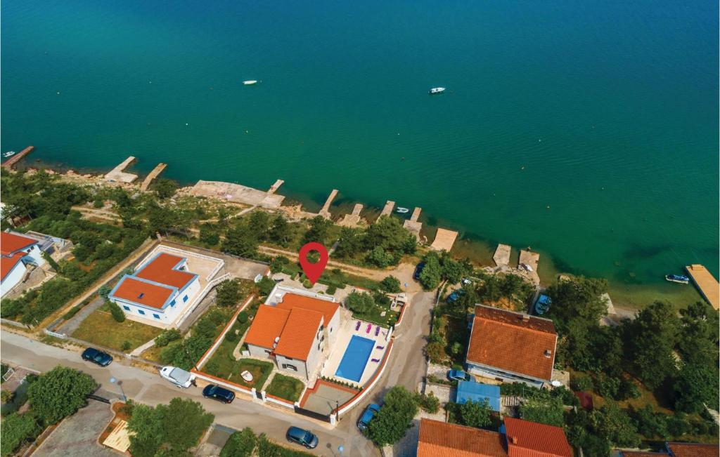 an aerial view of a house next to the water at Stunning Home In Klimno With Outdoor Swimming Pool in Klimno