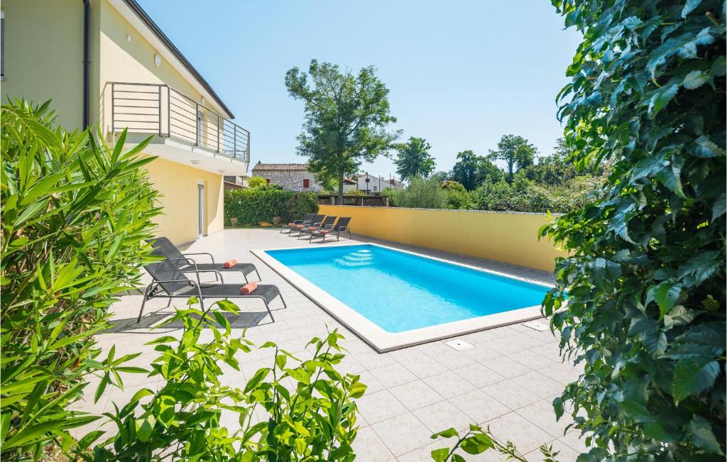basen z leżakami obok domu w obiekcie Four-Bedroom Holiday Home In Perci w mieście Perkovići