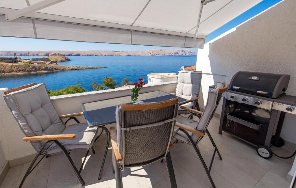 a balcony with a table and chairs and a grill at Gorgeous Apartment In Stinica With House Sea View in Stinica