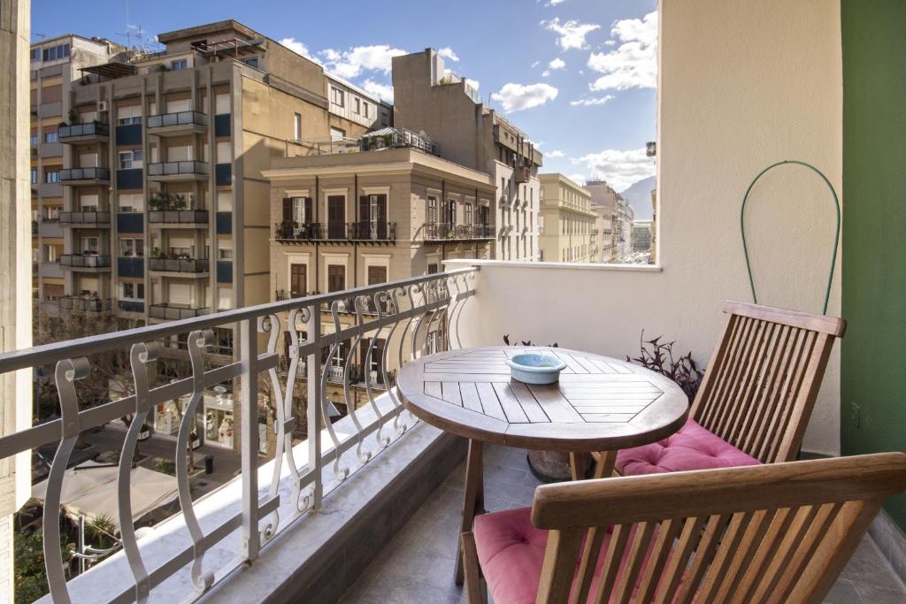 a balcony with a table and chairs and a view at Residenza Wagner in Palermo