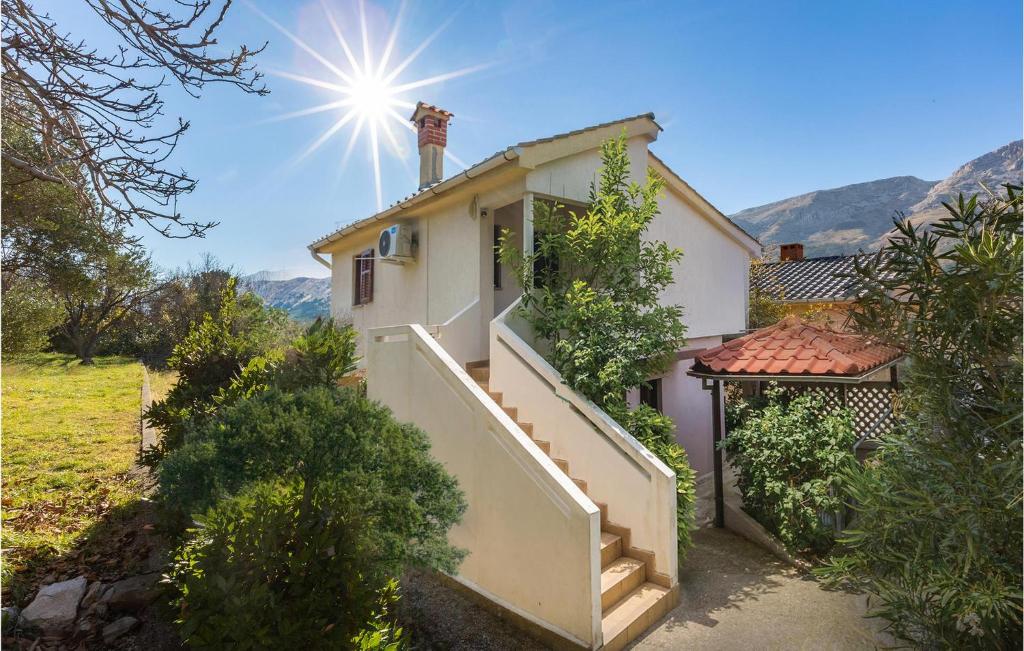 a house with a staircase and the sun in the sky at Nice Apartment In Bascanska Draga With Wifi in Draga Bašćanska