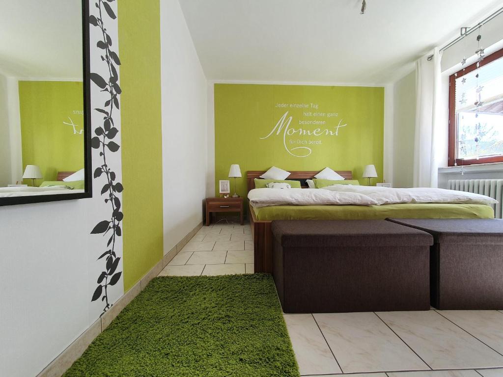 a bedroom with a bed and a green wall at Casa-Maria in Ehrenberg