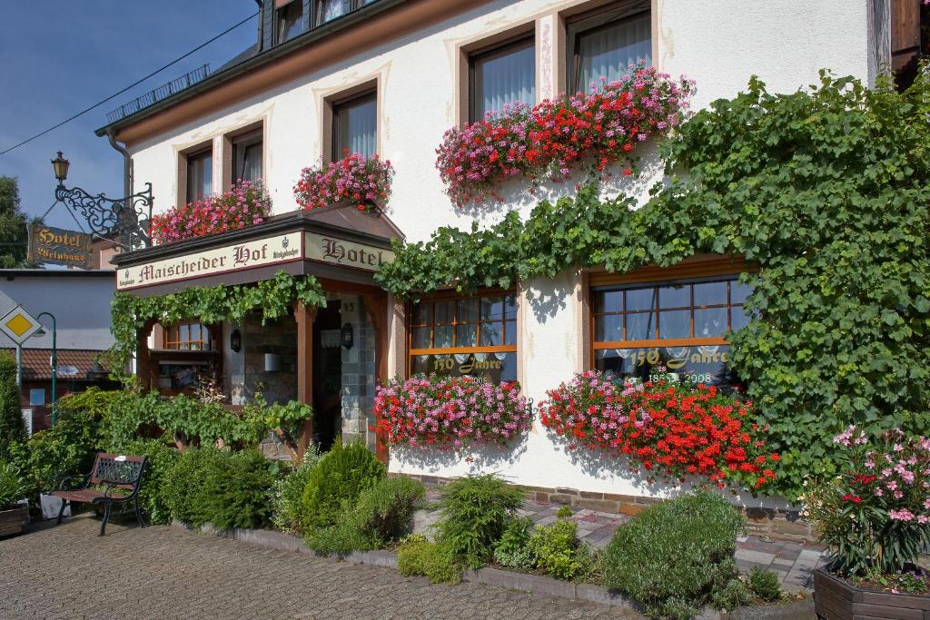 a building with flower boxes on the side of it at Maischeider Hof in Kleinmaischeid