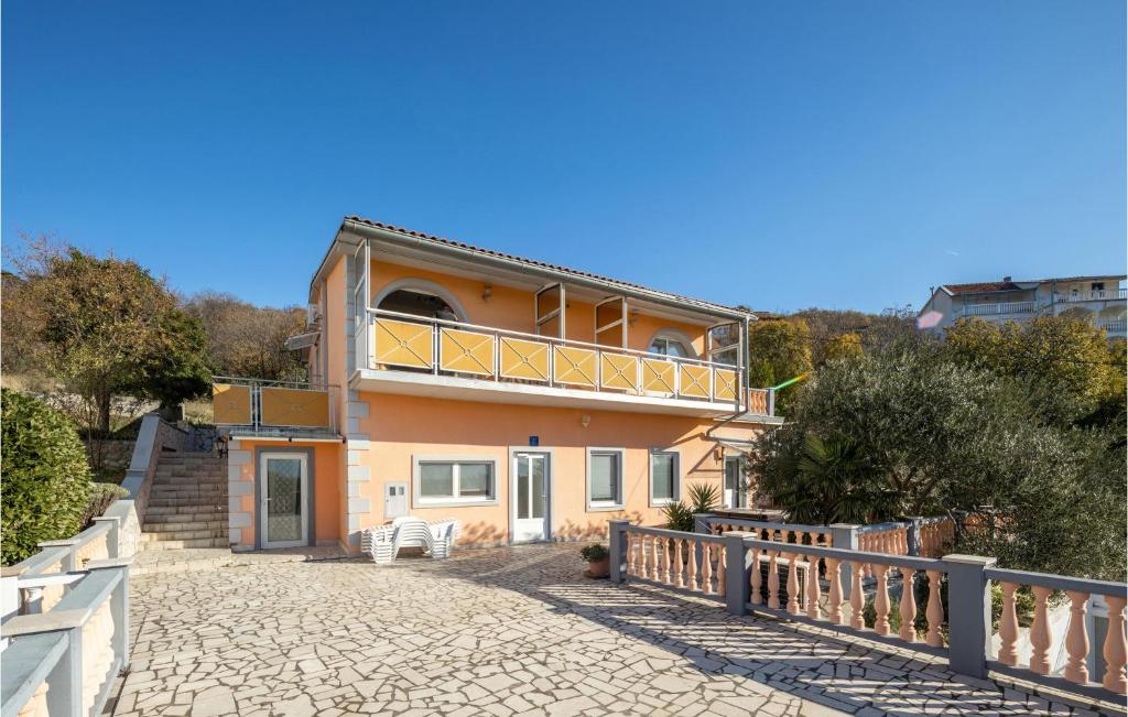 a house with a balcony on top of it at Awesome Home In Klenovica With House Sea View in Klenovica