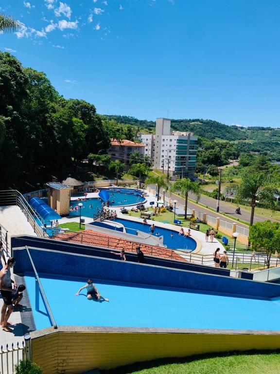 a large swimming pool with people swimming in it at Thermas Palace in Piratuba