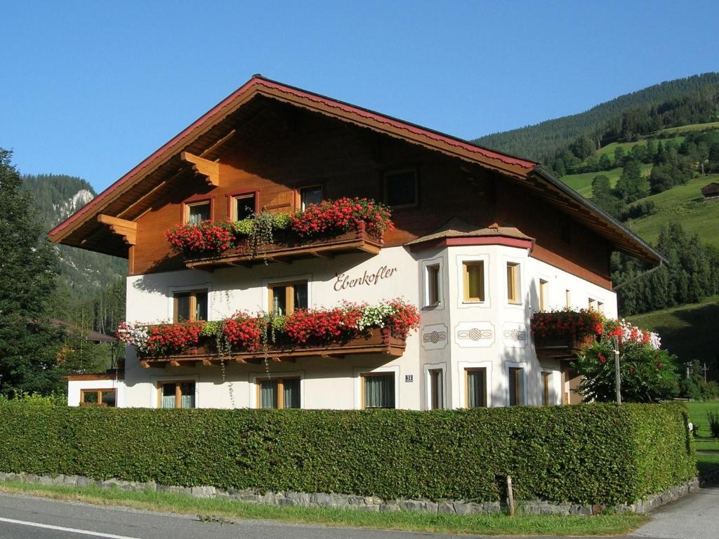 a building with flower boxes on the side of it at Cozy apartment in Wald K nigsleiten in Wald im Pinzgau