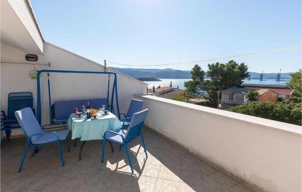 a patio with a table and chairs on a balcony at 2 Bedroom Awesome Apartment In Klek in Klek